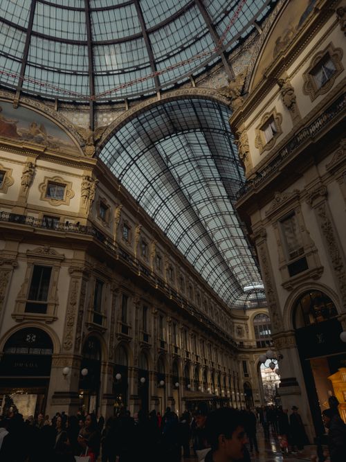 Free Elegant interior view of Galleria Vittorio Emanuele II with striking architecture in Milan, Italy. Stock Photo