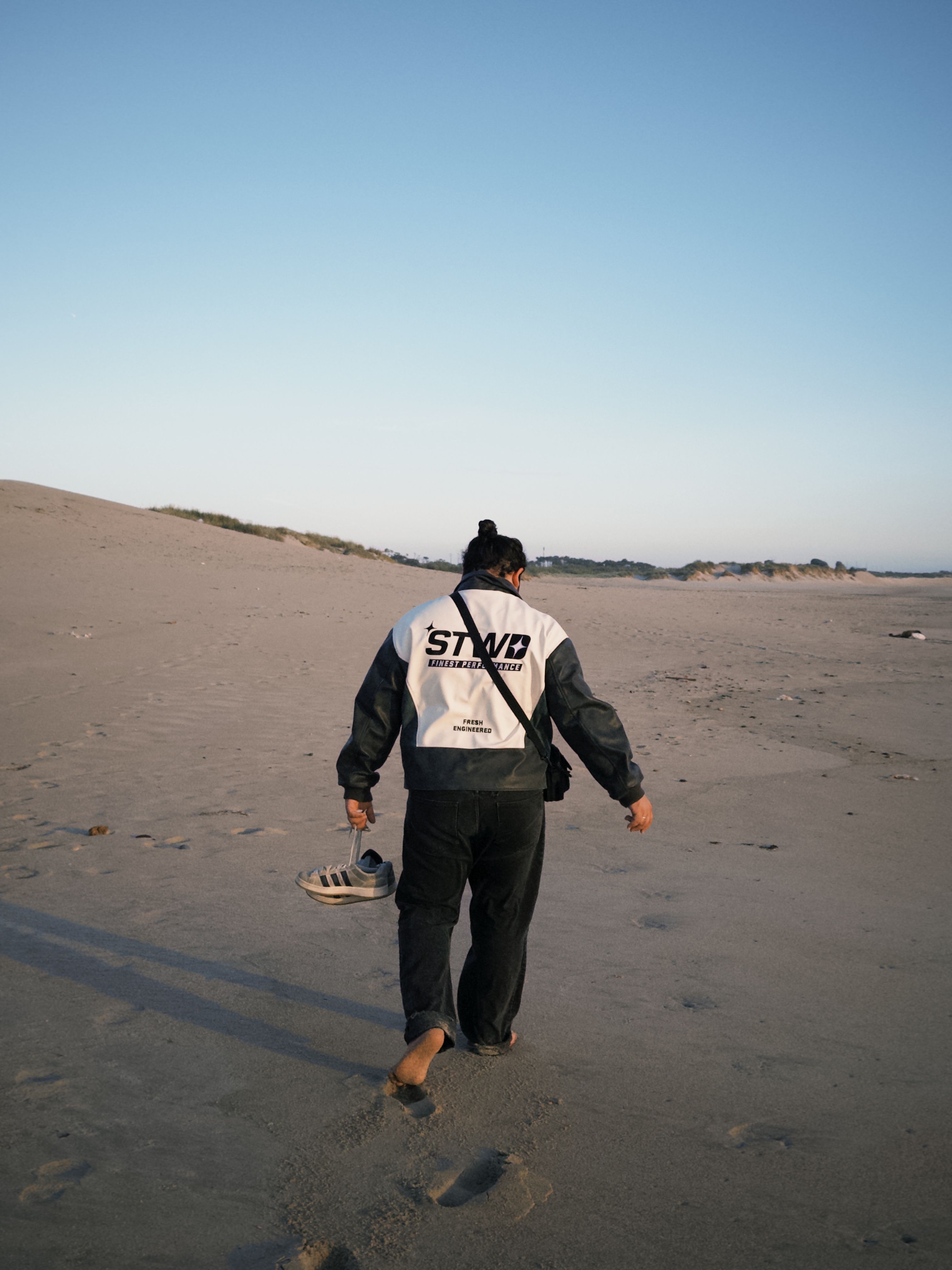 Man Walking on Sandy Beach at Sunset · Free Stock Photo