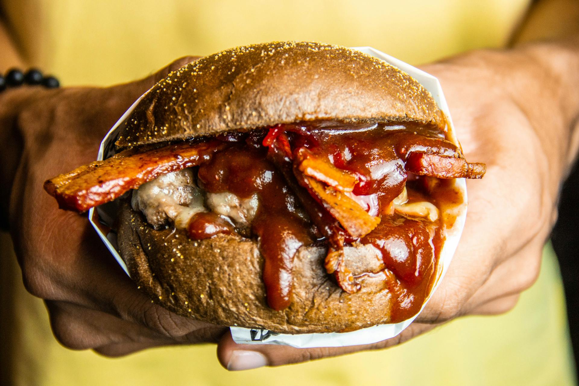 Person Holding  Grilled Cheese Burger