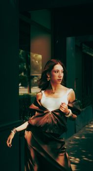 Stylish woman in elegant attire walking outdoors, exuding confidence and fashion-forward style.