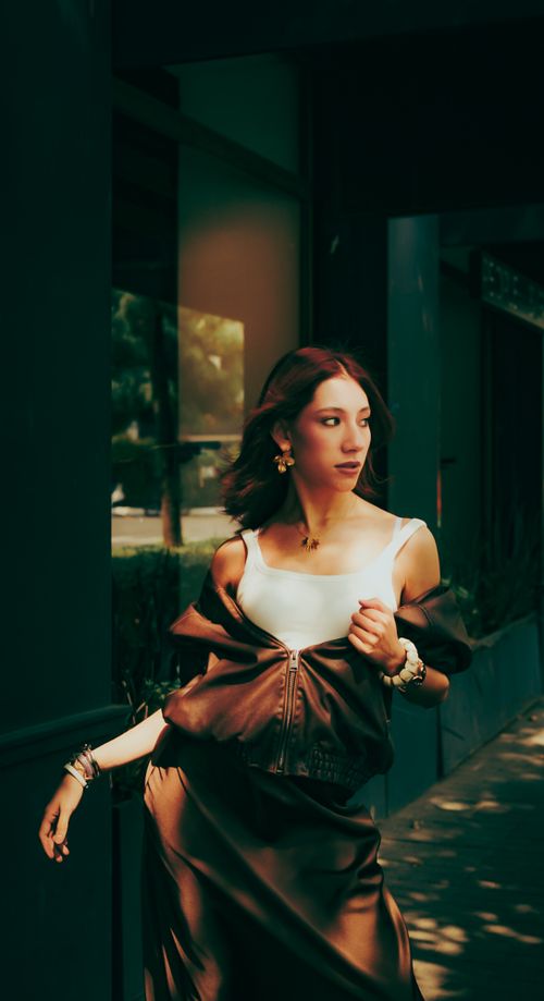 Free Stylish woman in elegant attire walking outdoors, exuding confidence and fashion-forward style. Stock Photo