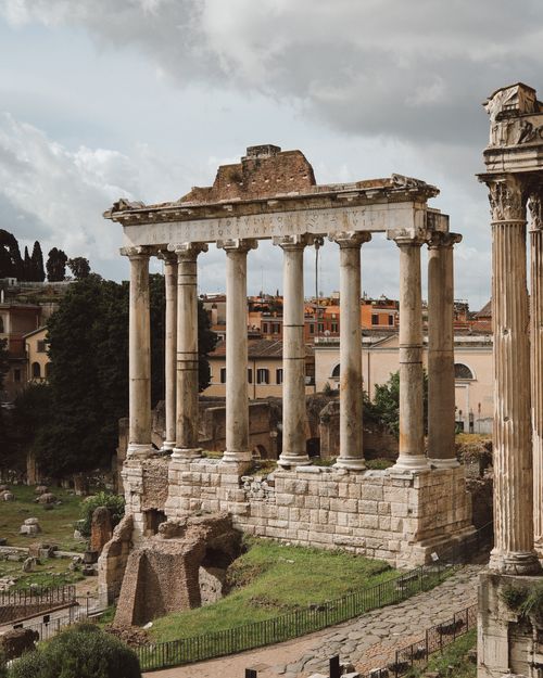 Free Historic Roman Forum ruins with columns under a cloudy sky in Rome, Italy. Stock Photo