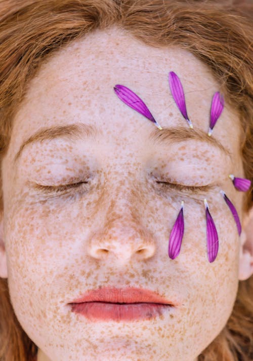 Free Person With Purple Petals Around The Eye Stock Photo