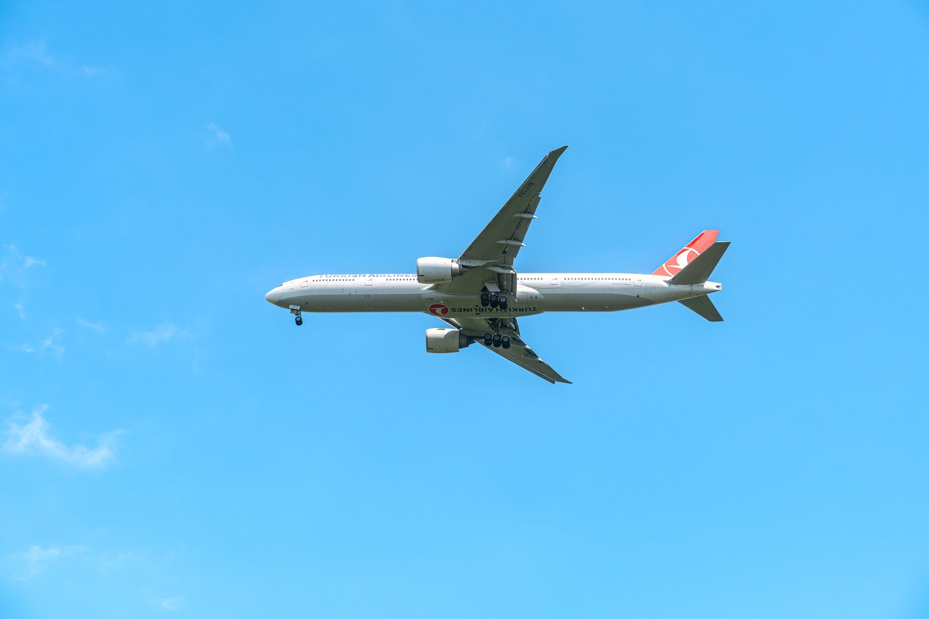 Commercial airplane soaring in the blue sky, perfect for travel or aviation themes.