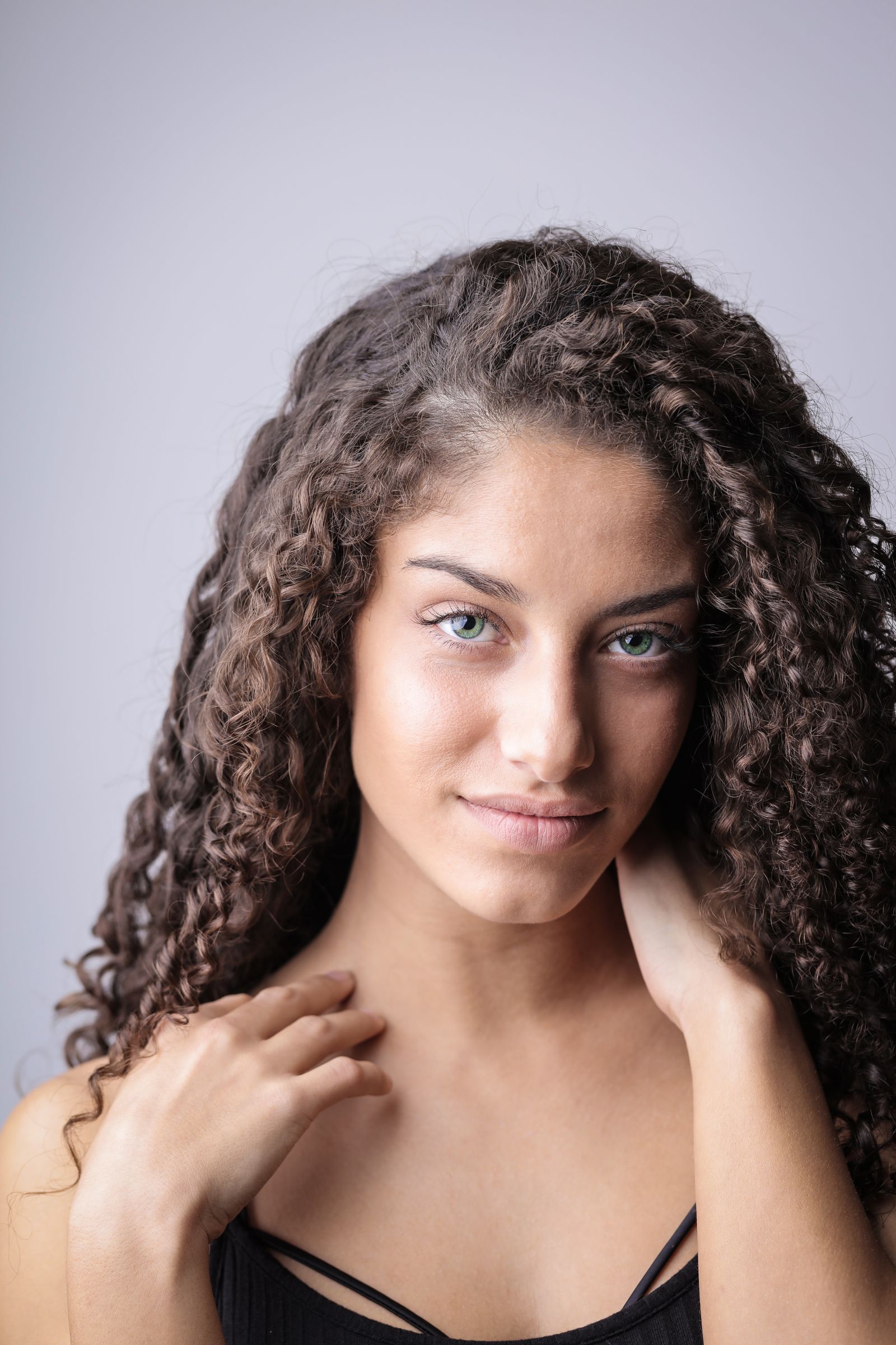 Long loose curls with deep side part party hairstyle