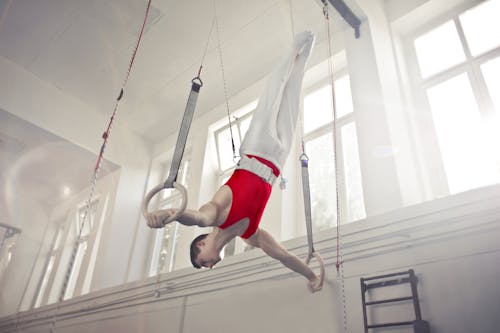 Free Photo of Male Gymnast Practicing on Gymnastic Rings Stock Photo