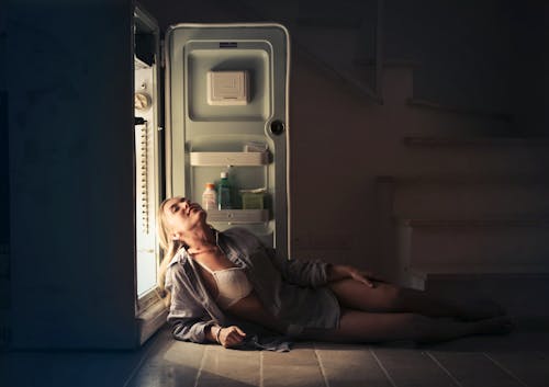 Free Photo of Woman in Dress Shirt and Bra Lying Down on the Floor Next to an Open Fridge Stock Photo