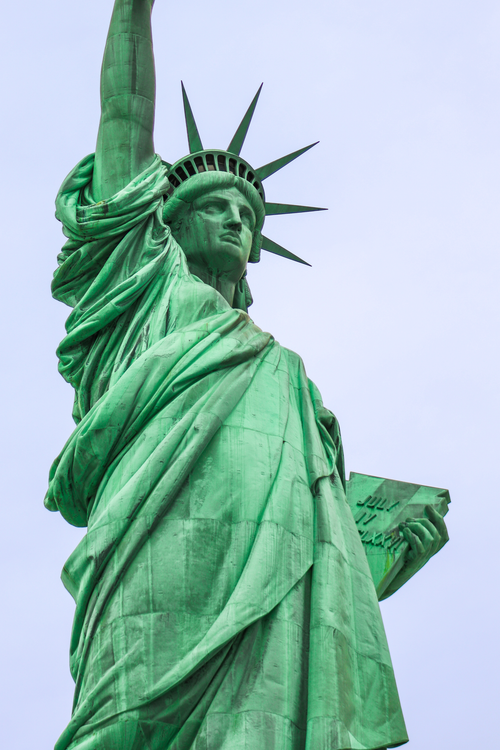 Free Detailed photograph of the iconic Statue of Liberty against a cloudy sky in New York City. Stock Photo