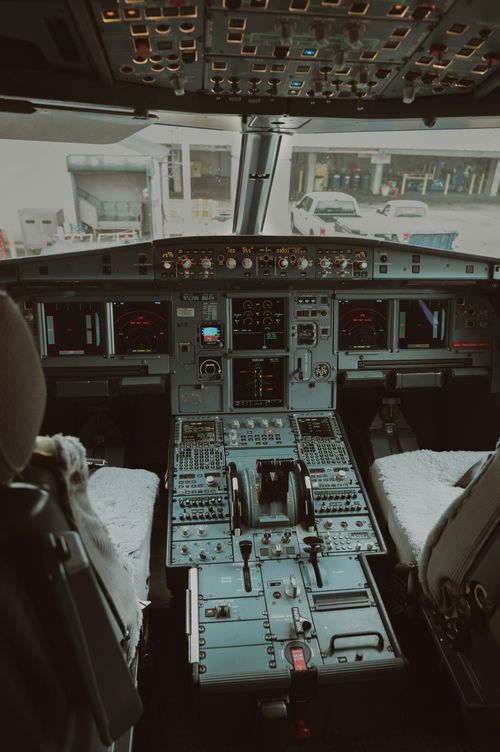 Free Detailed view of airplane cockpit with advanced controls and displays, showcasing aviation technology. Stock Photo