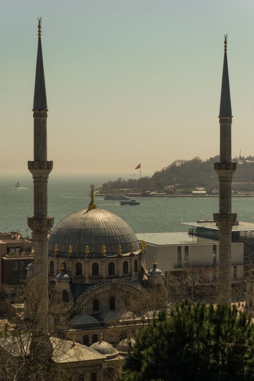 Free A stunning view of a mosque with minarets, set against the backdrop of the Bosphorus, Istanbul. Stock Photo