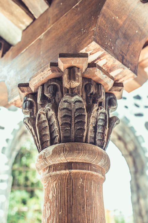 Free Close-up of a detailed carved wooden architectural column with ornate design elements. Stock Photo