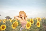 Woman Standing on Sunflower Field