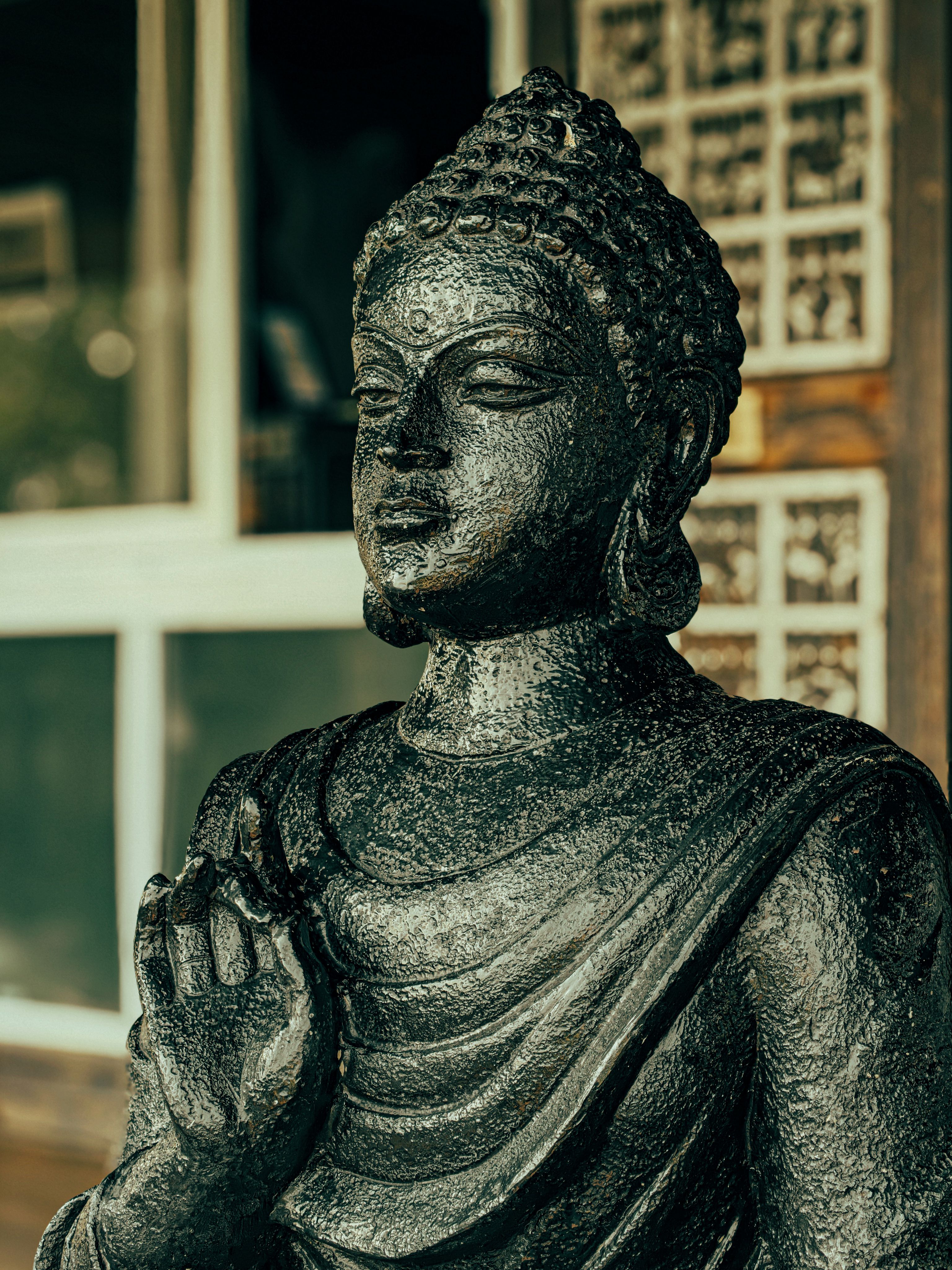 Serene Buddha Statue with Raised Hand Gesture · Free Stock Photo