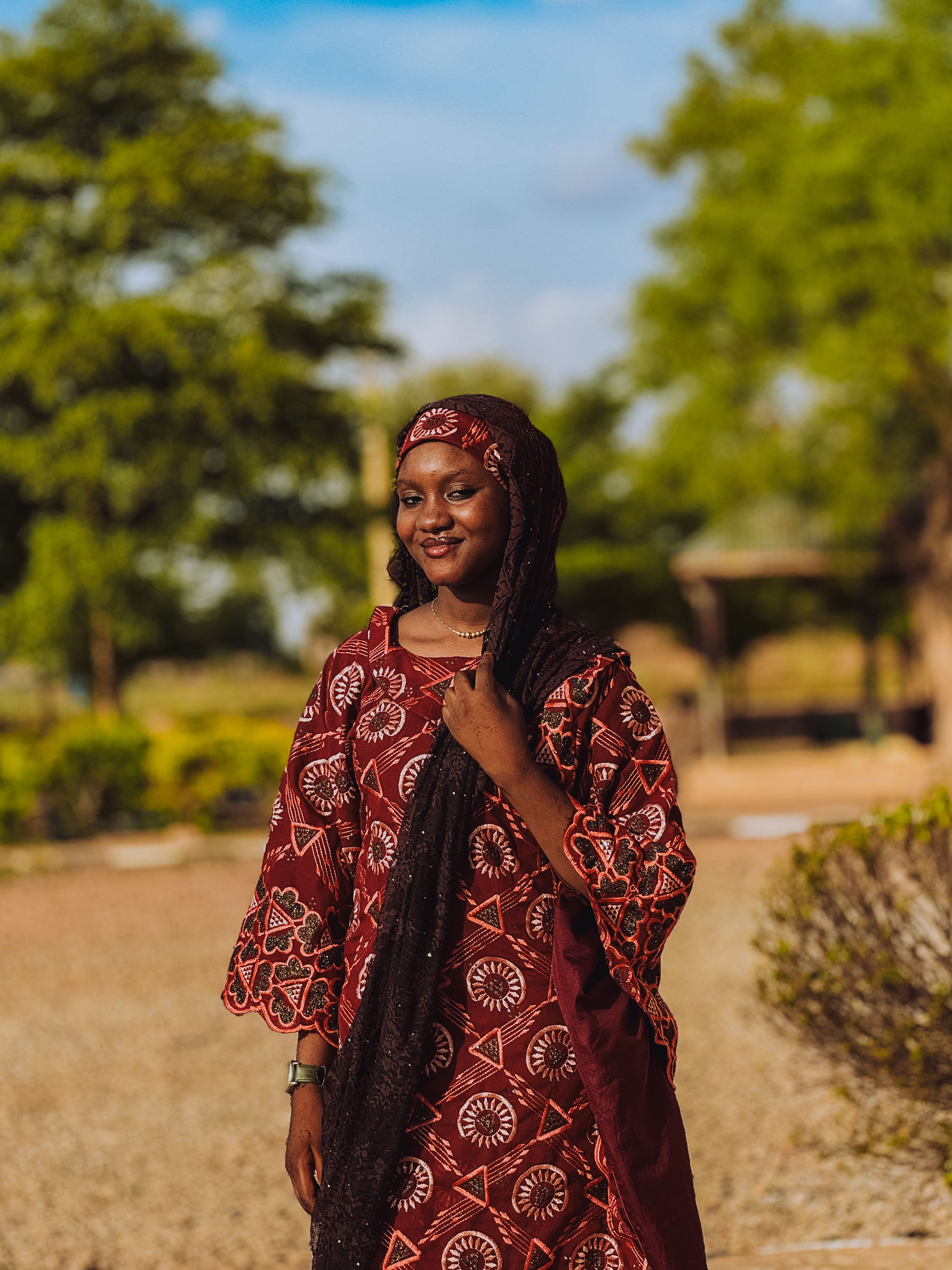 Smiling Woman in Traditional Dress Outdoors · Free Stock Photo