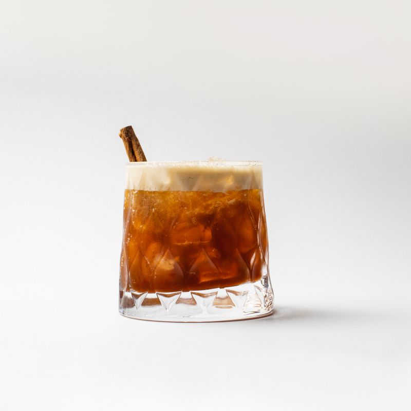 Dark cold brew over ice on white — photo by Efe Burak Baydar on Pexels