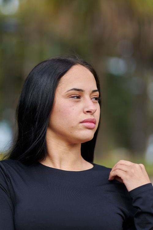Free Portrait of a thoughtful woman in black top outdoors, showcasing natural beauty and serene expression. Stock Photo