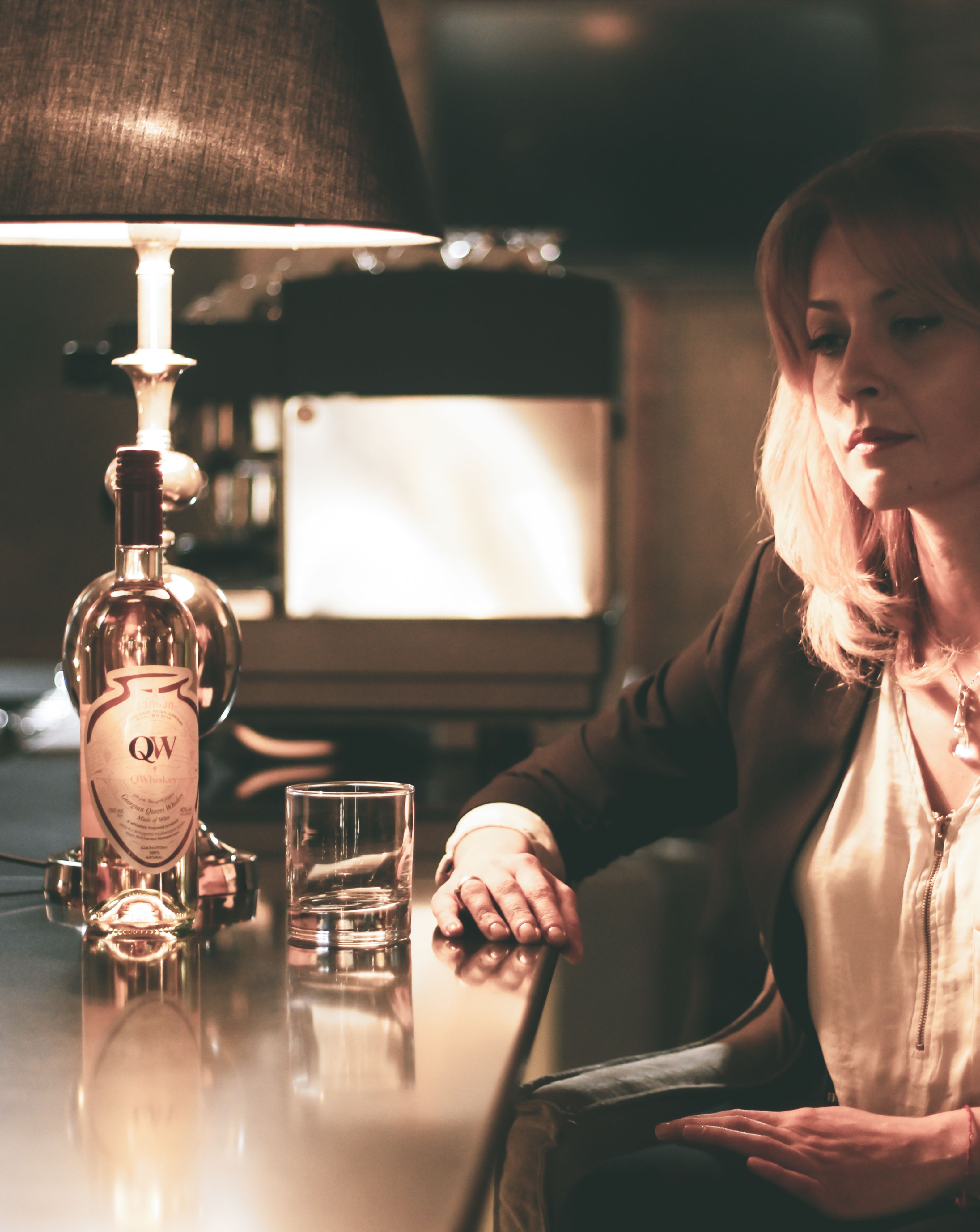 Pensive Young Woman Drinking Alcohol Beverage In Bar Free Stock Photo