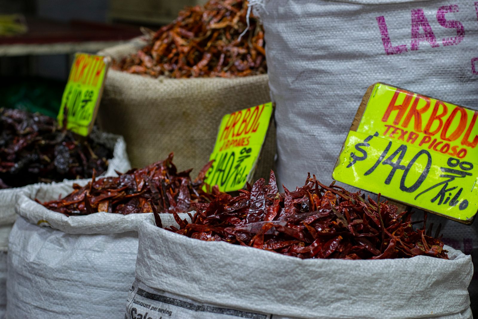 Dried chilies displayed in market sacks with price tags
