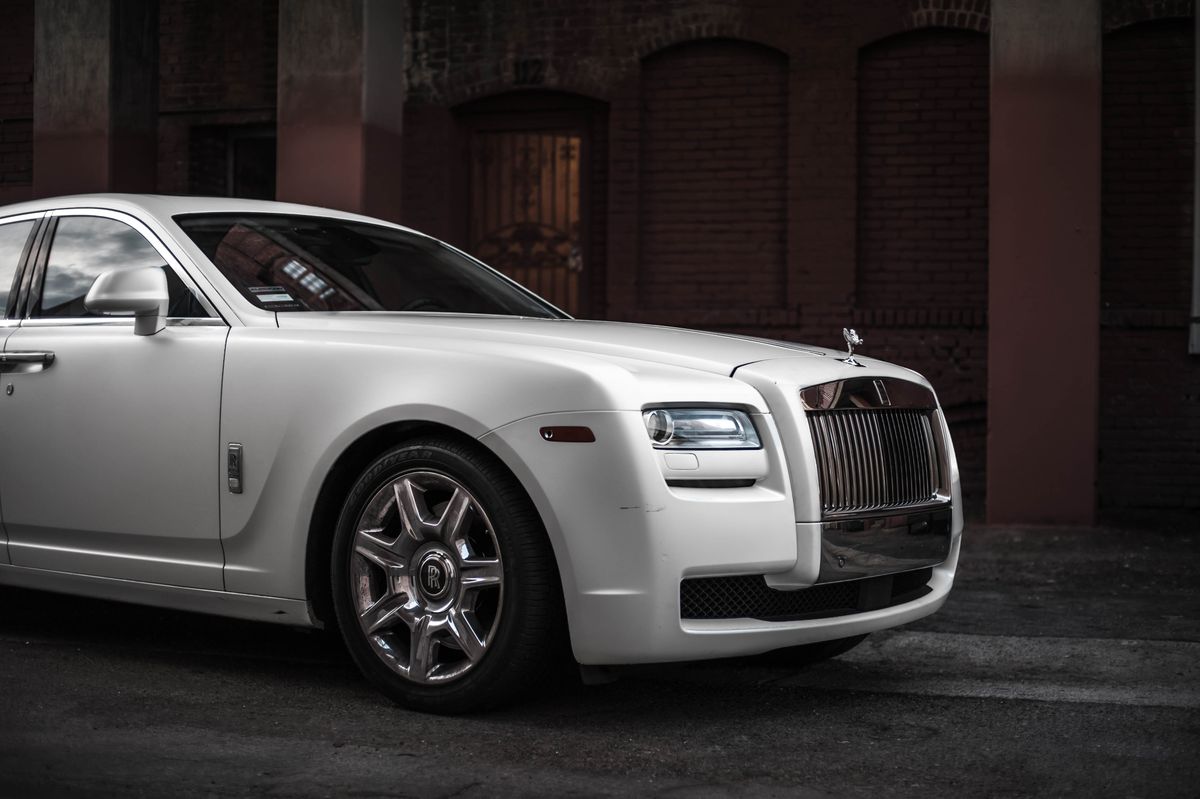 White Rolls-Royce Ghost parked near elegant building