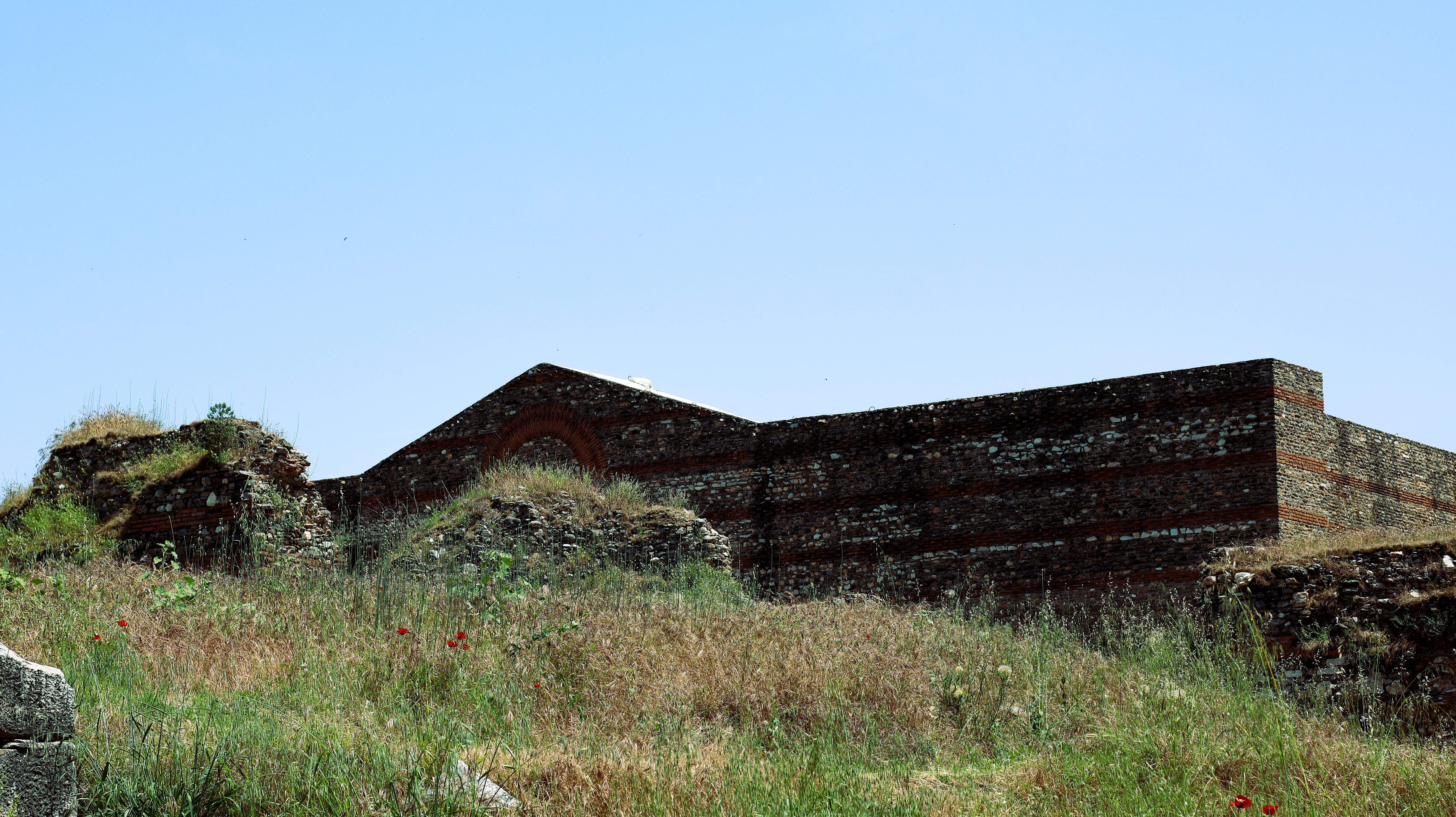 Ancient Ruins in a Grassy Field under Blue Sky · Free Stock Photo