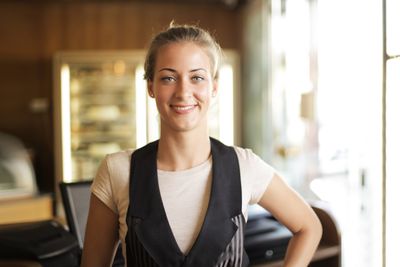 Portrait of a smiling blonde woman standing indoors