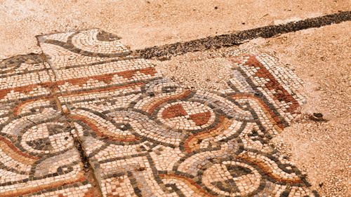 Free Intricate ancient Roman mosaic displaying geometric patterns with earthy hues. Stock Photo