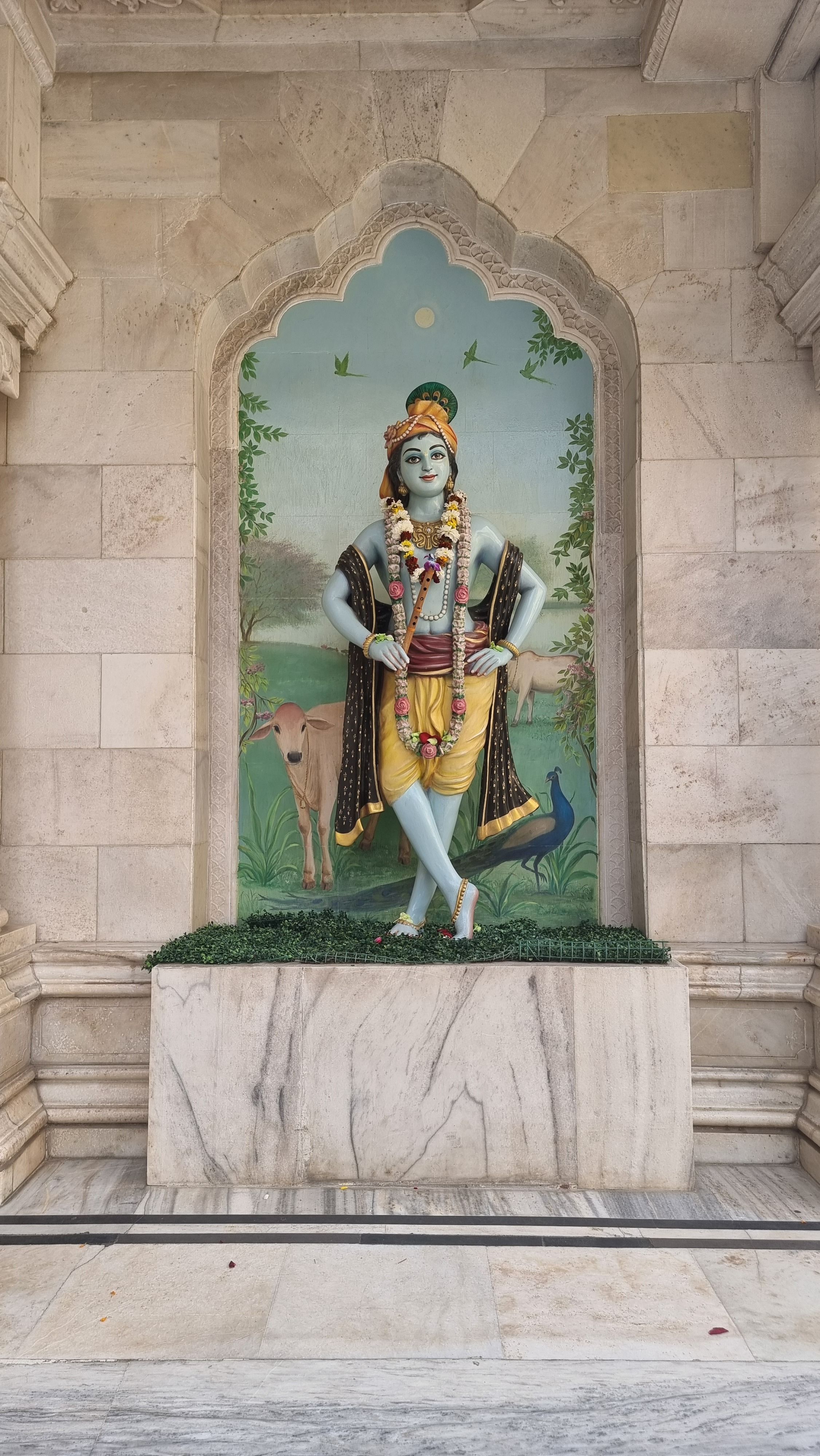 Beautiful Krishna statue surrounded by architectural details at ISKCON Temple, Vrindavan.