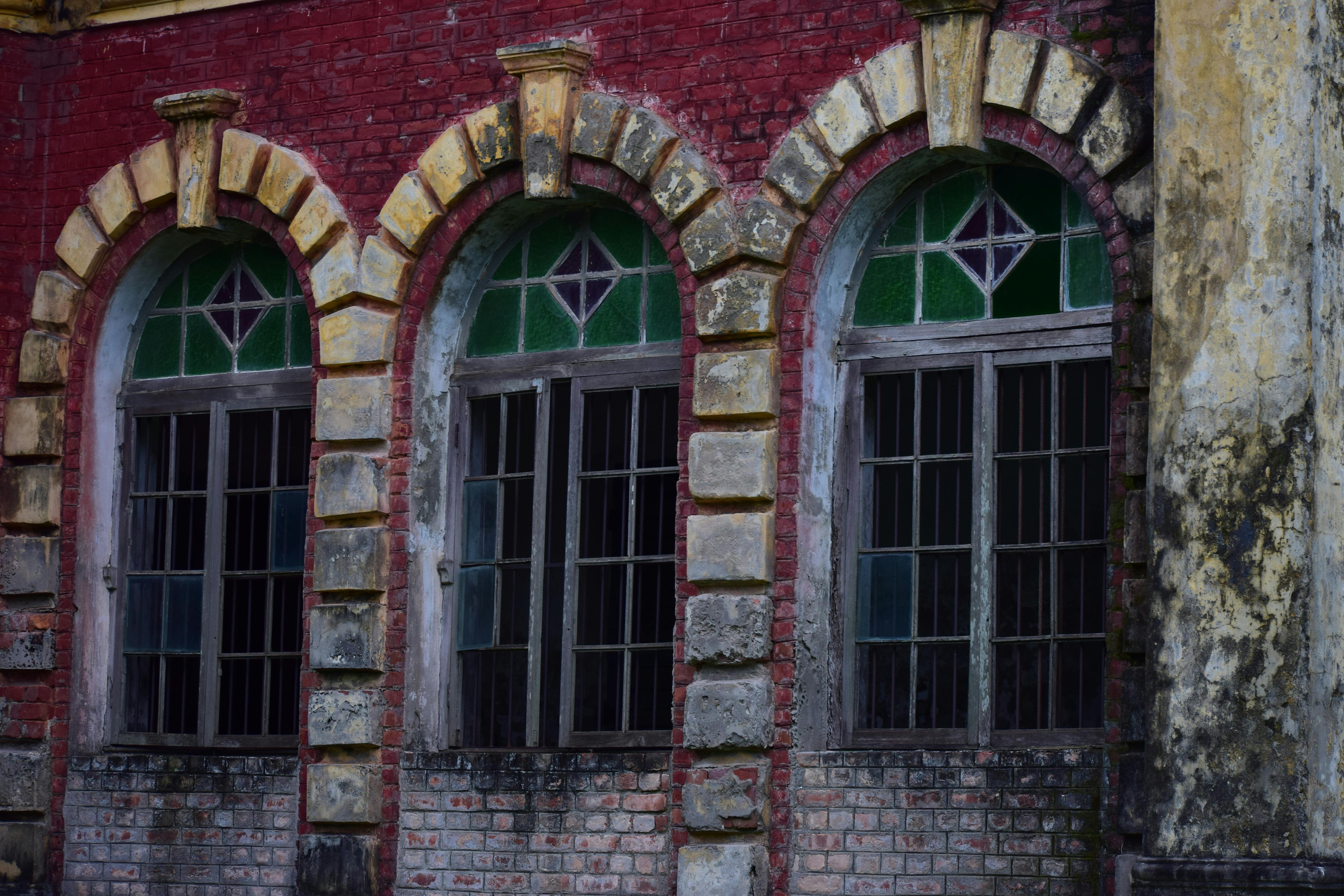 Close-up of Shoshi Lodge's intricate arched windows showcasing historical architecture in Mymensingh, Bangladesh.