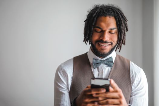 Portrait Photo of Smiling Man in White Dress Shirt and Brown WaistcoatTexting
