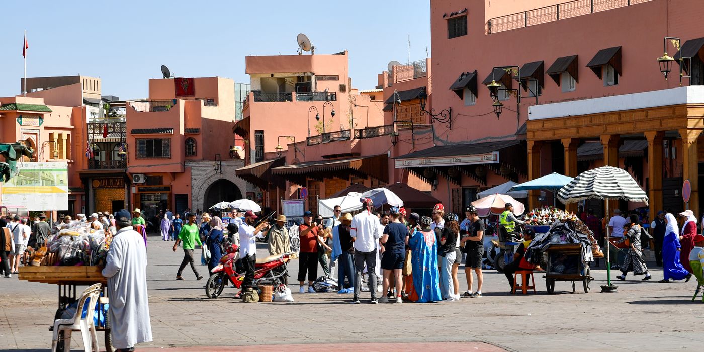 Crowds and market umbrellas filling the Jemaa el-Fna square in Marrakech during the day