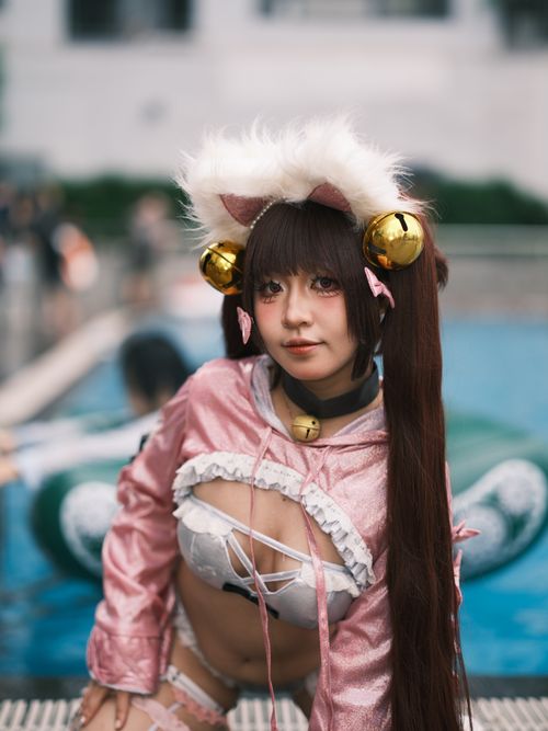 Free A young woman in a detailed cosplay costume at an outdoor pool, showcasing vibrant style. Stock Photo