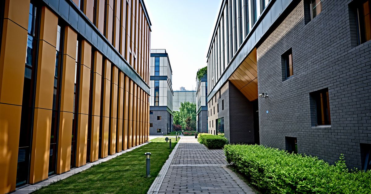 Vibrant view of modern office buildings with pathway and greenery.