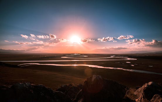 日出时，蜿蜒的河流在广阔的草原上显得格外壮观