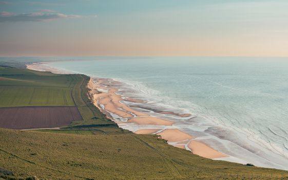 A breathtaking view of the coastline in Hauts-de-France, showcasing rolling fields and sandy beaches.