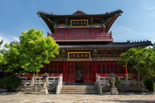 Free Front view of traditional Chinese temple with intricate architecture on a sunny day. Stock Photo