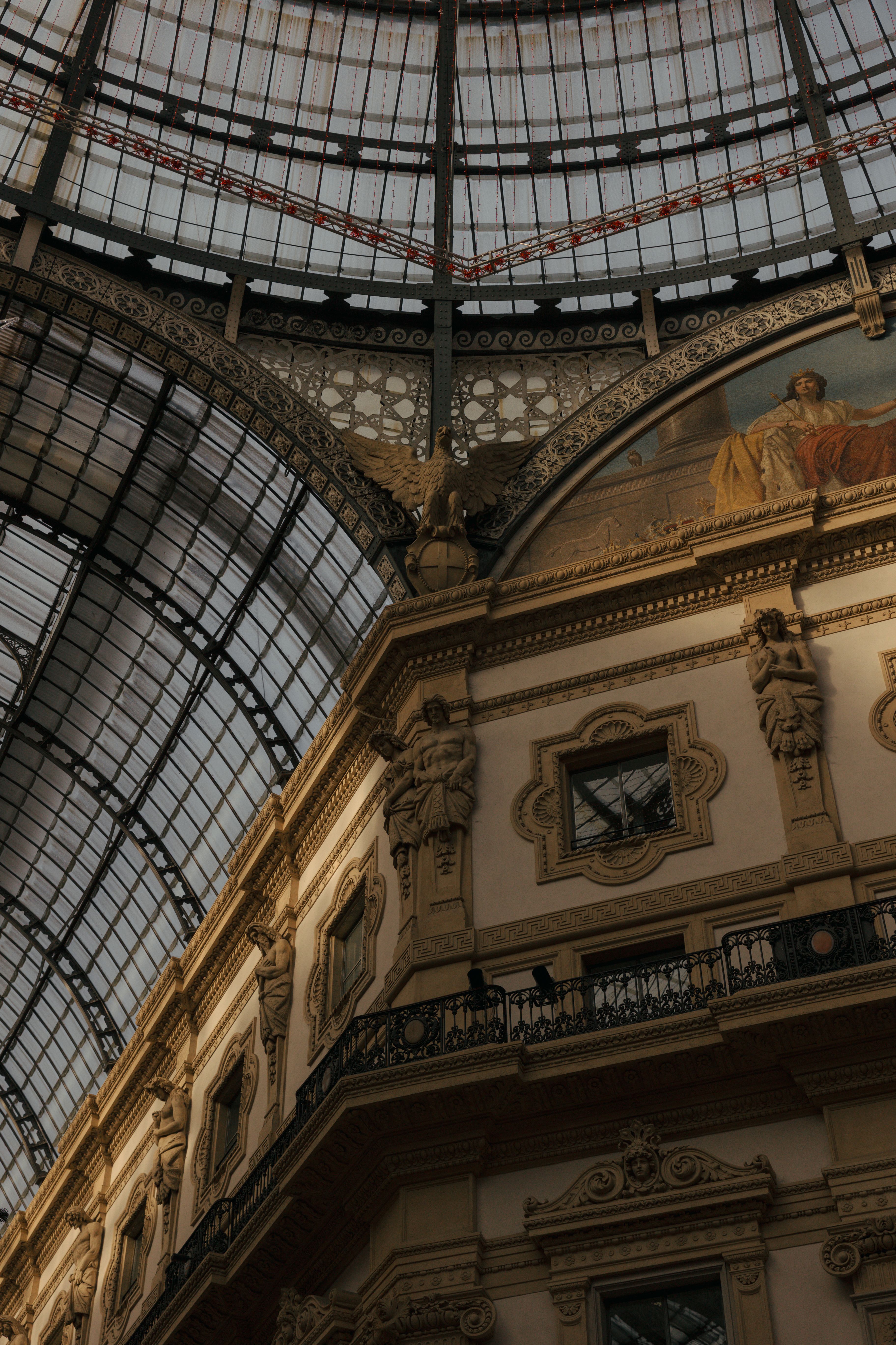 View of the elegant architecture and glass ceiling in Galleria Vittorio Emanuele II, Milan, Italy.