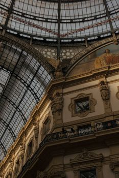 View of the elegant architecture and glass ceiling in Galleria Vittorio Emanuele II, Milan, Italy.