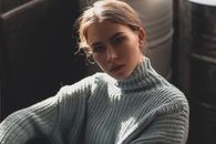 Close-up portrait of a woman in a cozy sweater, exuding elegance and warmth.