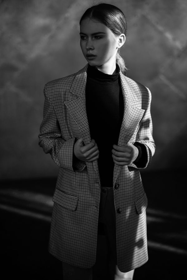 Woman in turtleneck dress with thrifted blazer