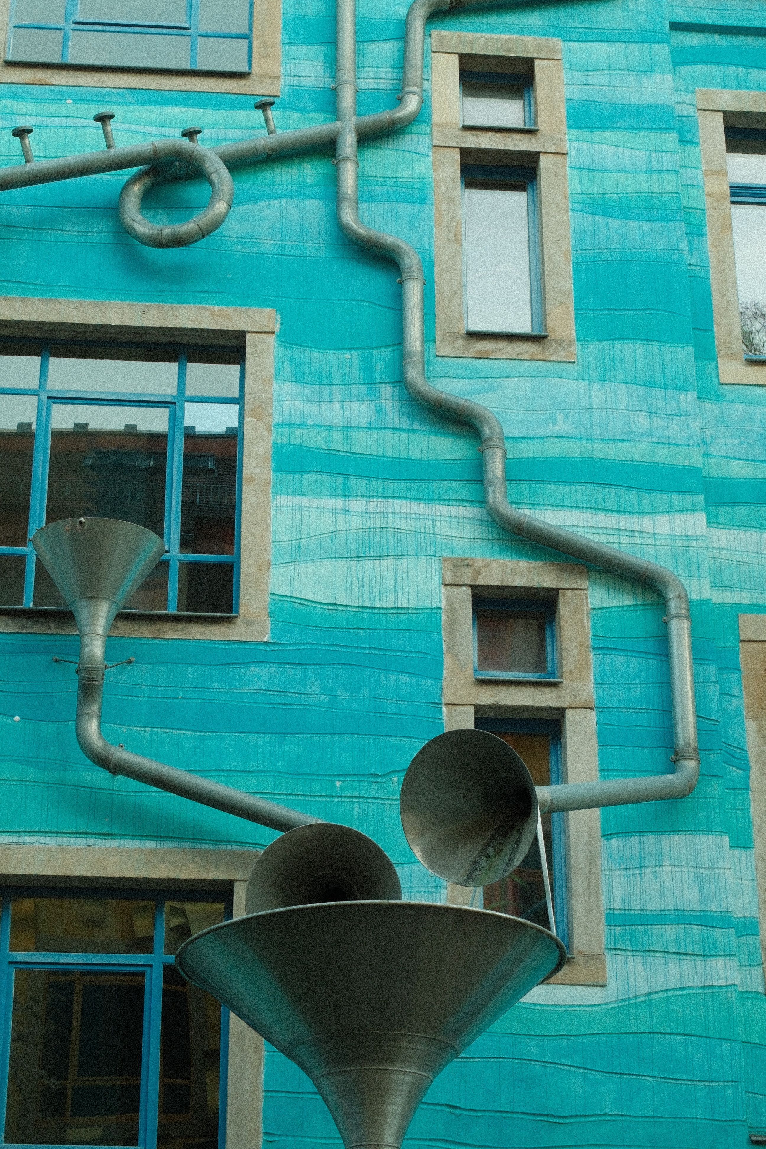 Colorful building in Dresden with a creative funnel-based water system.