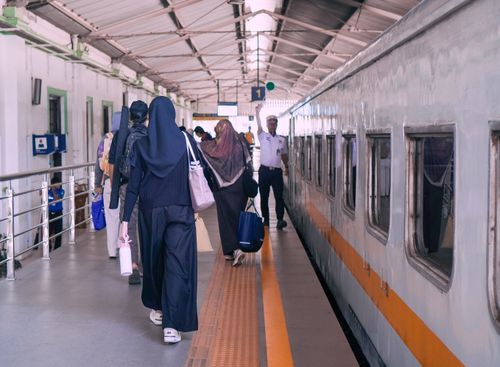 Free People boarding a train at Bandung station, Indonesia. Capturing busy travel moments. Stock Photo