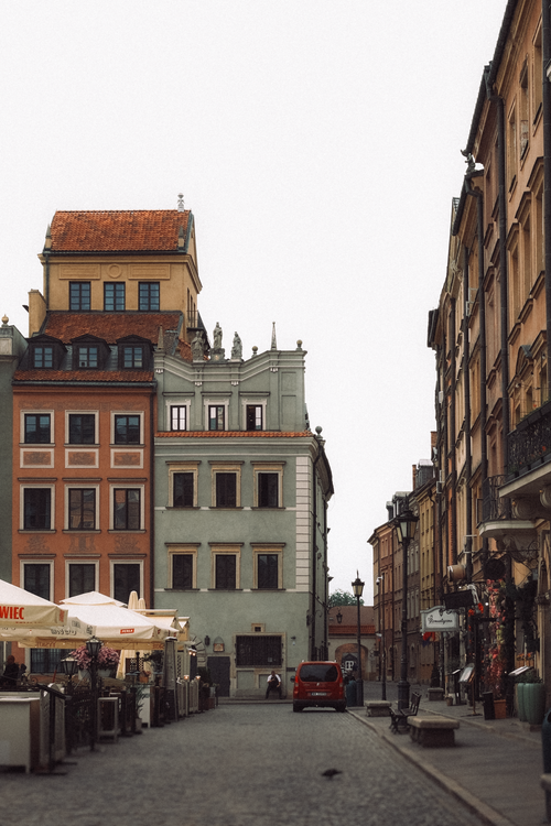 Free Quaint street view in Warsaw's Old Town featuring colorful buildings and a quiet atmosphere. Stock Photo