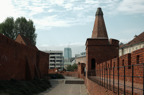 Free A mix of historic brick architecture and modern cityscape in Warsaw, Poland. Stock Photo