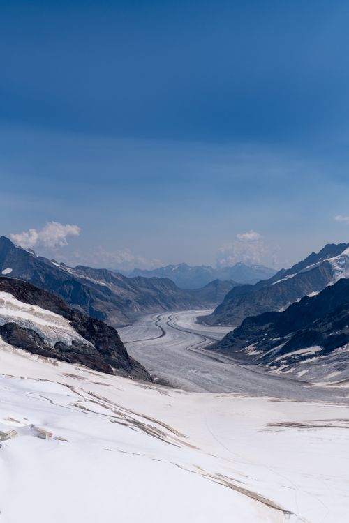 Free Majestic panoramic view of the Aletsch Glacier in the Swiss Alps with clear blue skies. Stock Photo