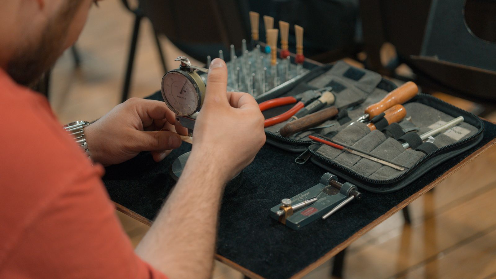 Technician using a dial indicator on a workshop bench
