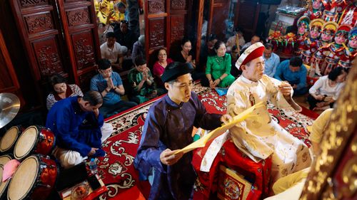 Free A vibrant Hau Dong ceremony in Hanoi, showcasing cultural practices and traditional attire. Stock Photo