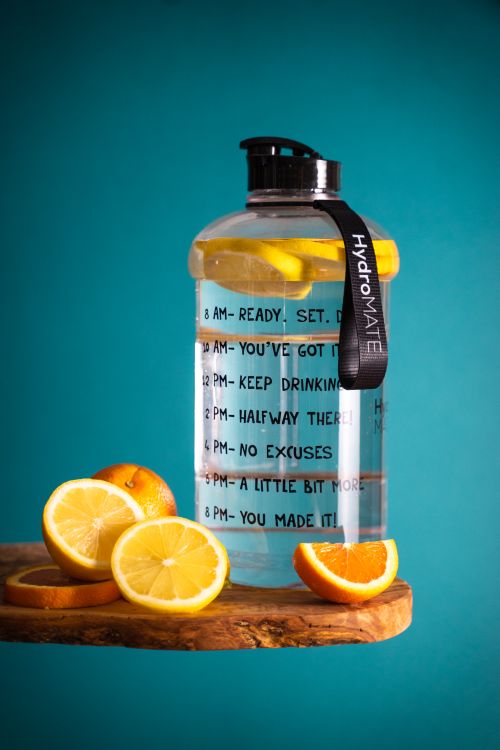 Free Slice Lemon Beside Glass Pitcher on Wooden Table Stock Photo