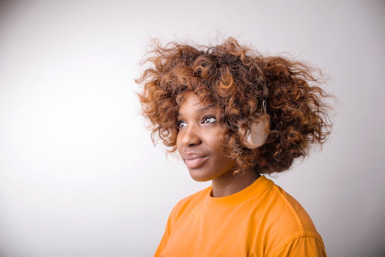 Woman In Orange Crew Neck Shirt Wearing Headphone