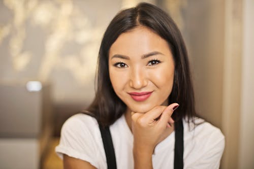 Free Selective Focus Photo of Smiling Woman in White T-shirt Posing Stock Photo