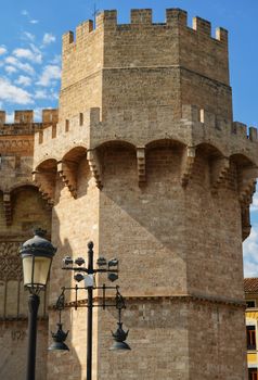 Close-up of the historic Serranos Towers in Valencia, Spain under a clear blue sky.